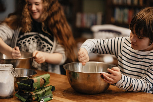 Budding Homeschoolers cook with mom in the kitchen
